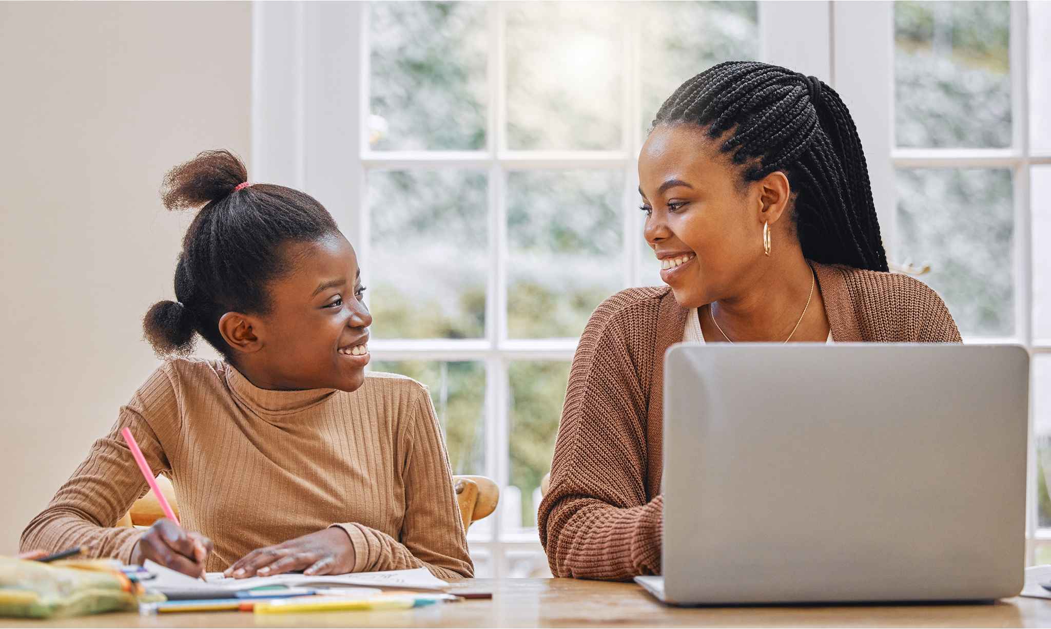 Mother and daughter looking at eachother and smiling